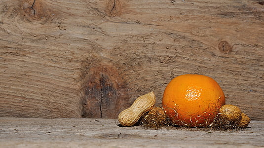 orange and peanuts on brown wooden board thumbnail
