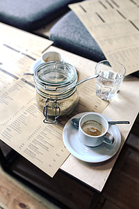 empty white ceramic cup near clear glass jar thumbnail