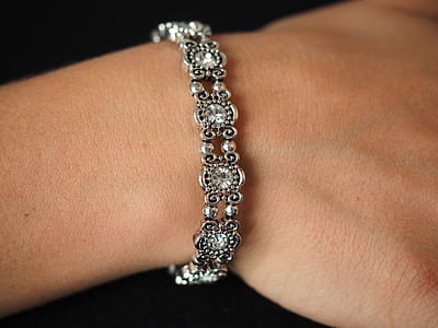 person wearing silver-colored bracelet thumbnail