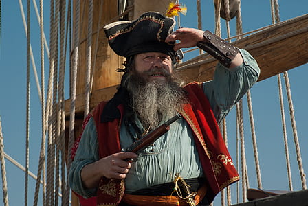 man wearing pirate suit on holding gun thumbnail