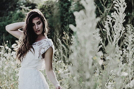 woman in white dress standing near plants thumbnail