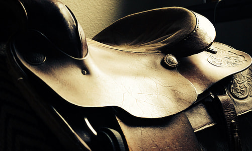 close shot of brown leather horse saddle thumbnail
