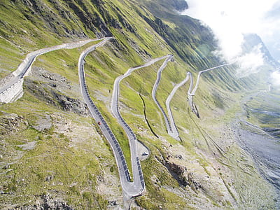 gray zigzag road under sunny sky thumbnail