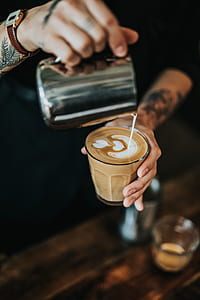 man pouring milk on cafe late art thumbnail