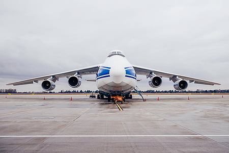 white and blue airplane under white sky during daytime thumbnail