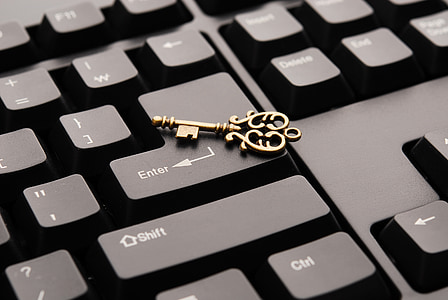 gold-colored skeleton key on computer keyboard thumbnail