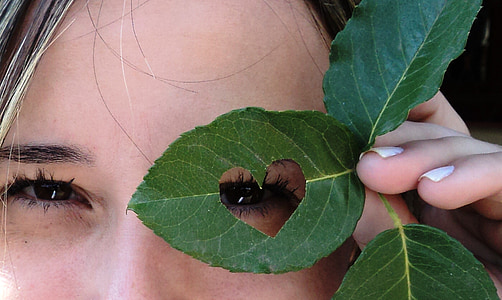 person holding heart cutout leaf thumbnail