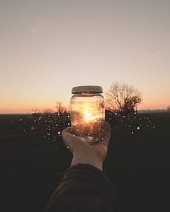 person holding clear glass jar thumbnail