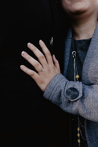 person wearing gold-colored ring thumbnail