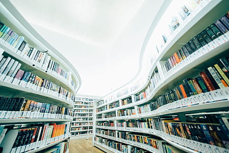 assorted-title book collection in white bookshelf thumbnail