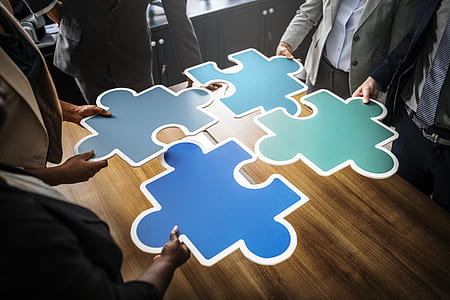four people holding giant jigsaw puzzles thumbnail