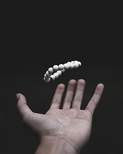 beaded white bracelet on person's palm thumbnail