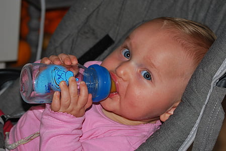 baby holding feeding bottle thumbnail