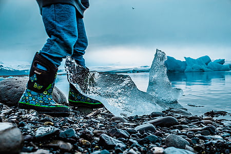person standing near iceberg thumbnail