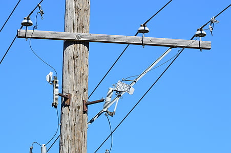gray wooden electric post under blue sky during daytimne thumbnail