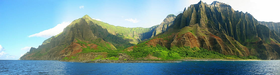 body of water over mountain at daytime thumbnail