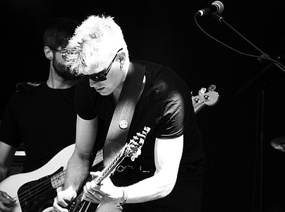 grayscale photo of man wearing guitar thumbnail