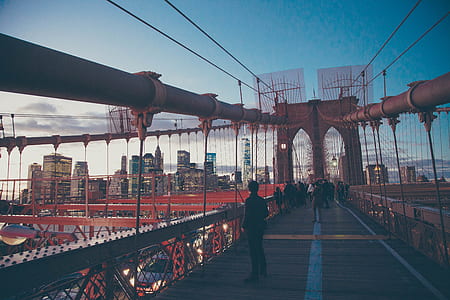 man in black pants standing on bridge thumbnail