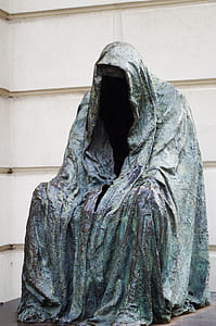 photo of person wearing cape statue thumbnail