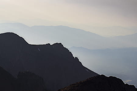silhouette of mountains covered by fog thumbnail