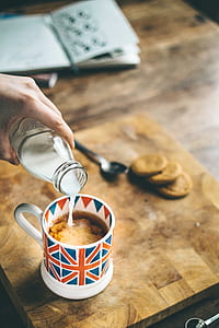 person pouring milk on coffee thumbnail