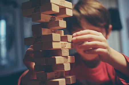 boy playing jenga blocks thumbnail