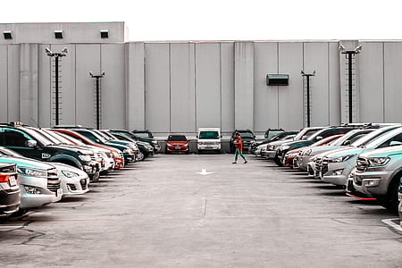person passing the middle of vehicle parking area thumbnail
