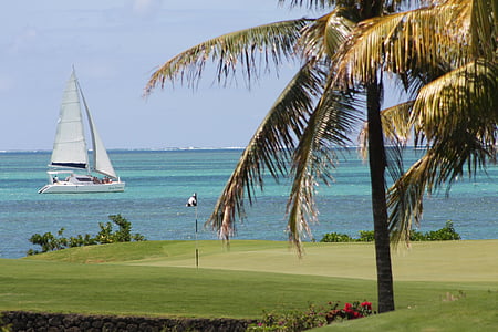 golf flag in front of sailboat on blue body of water thumbnail