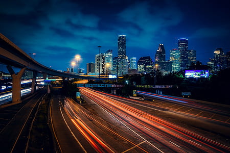 time lapse photography of car lights on street road during night time thumbnail