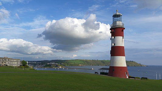 red and white striped lighthouse near body of water thumbnail