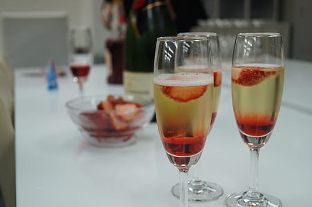 selective focus photography of flute glasses on white table thumbnail