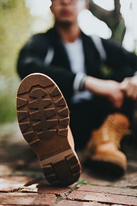 man wearing brown work boots thumbnail