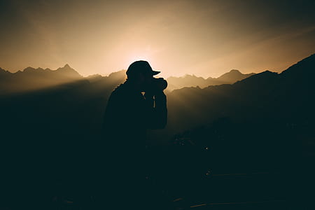 silhouette of man holding camera thumbnail