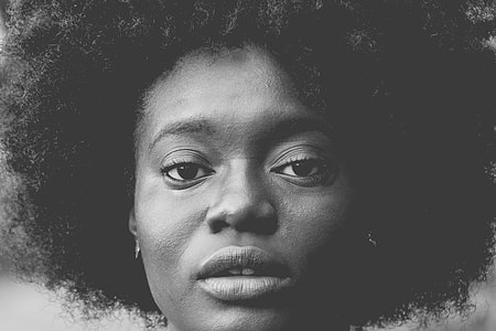 woman black curly hair thumbnail