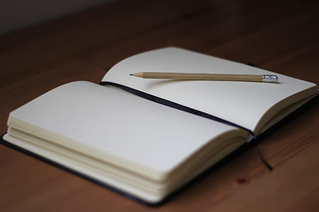 pencil on open blank notebook thumbnail