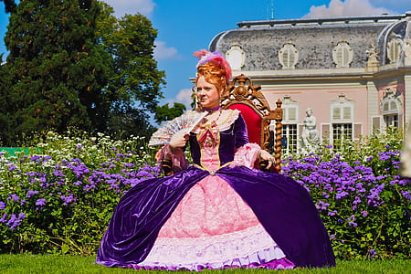 woman in purple and pink dress sitting on chair thumbnail