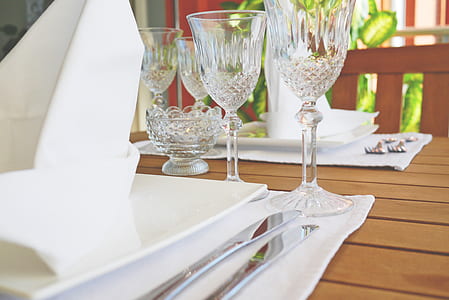 plate, knife, fork and drinking glasses on table thumbnail
