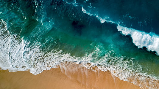waves in sand during daytime thumbnail
