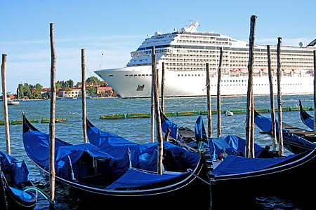 blue and black canoe boat on body of water thumbnail
