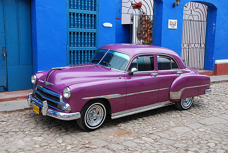 classic pink car parked on road side thumbnail