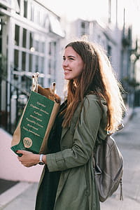 Photo of a Woman Carrying a Paper Bag thumbnail