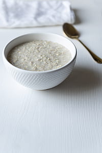 white ceramic bowl besides stainless steel spoon thumbnail