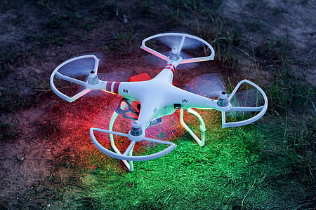 white DJI drone on green grass thumbnail
