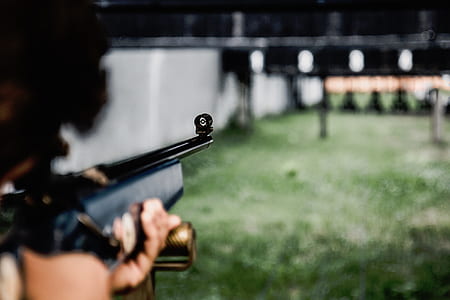 person aiming target using rifle thumbnail