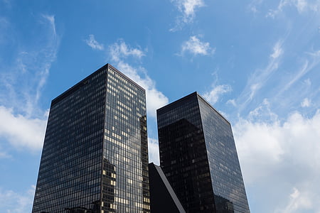 low angle photography of high rise building under white clouds during daytime thumbnail
