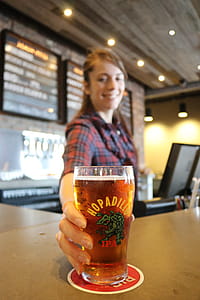 Woman Holding Glass Bottle With Beer thumbnail