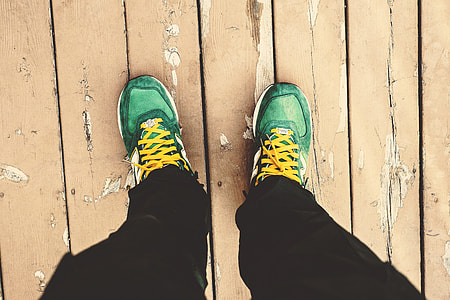 A man looking down at his green sneakers thumbnail