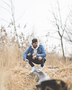 man sitting on tree trunk thumbnail