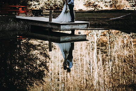 couple standing dock bridge thumbnail