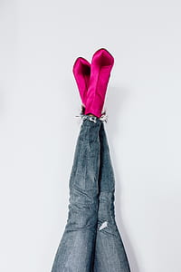 A woman in pink boots and blue jeans thumbnail